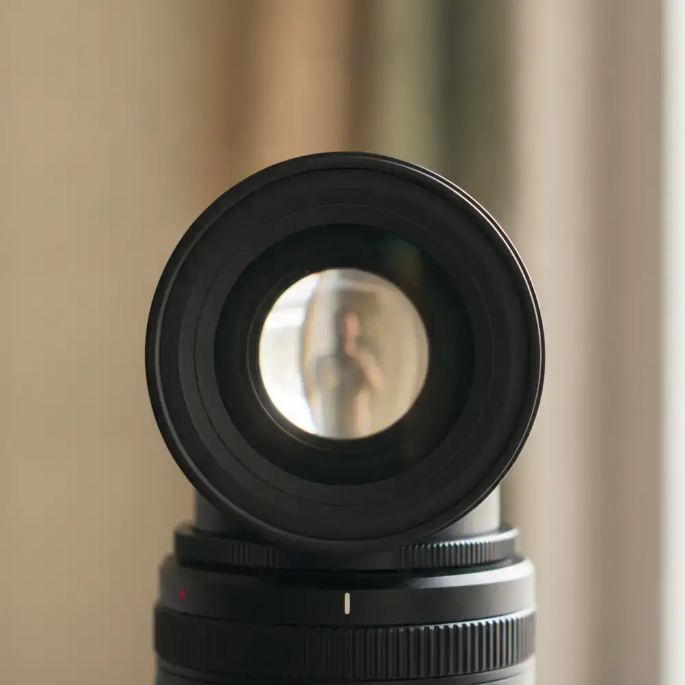 Close up of a camera lens focusing on a subject